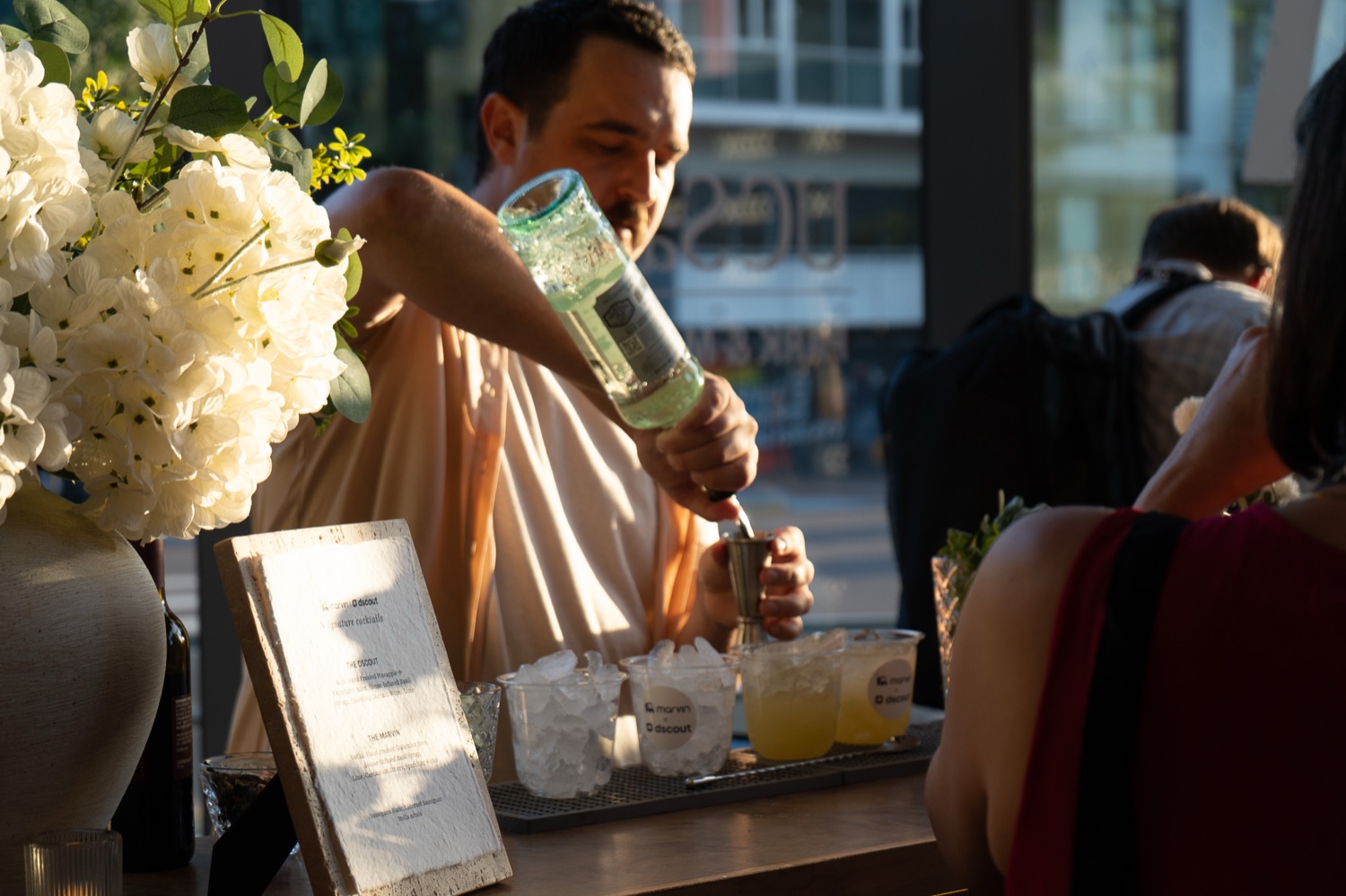 A bartender finishing a drink